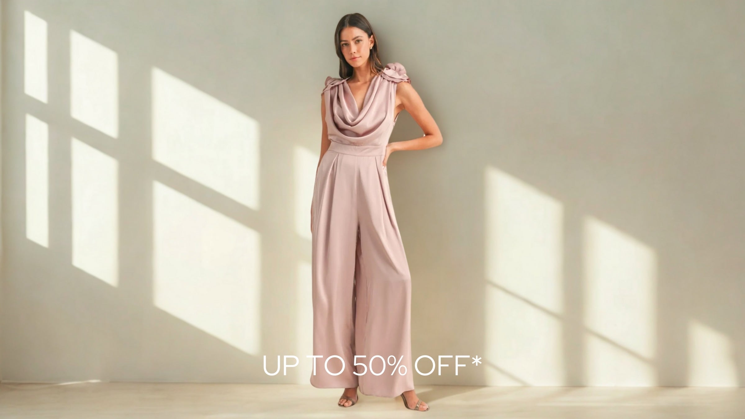 Blushe Belle Woman in a pink dress standing in a sunlit room with promotional text overlay.